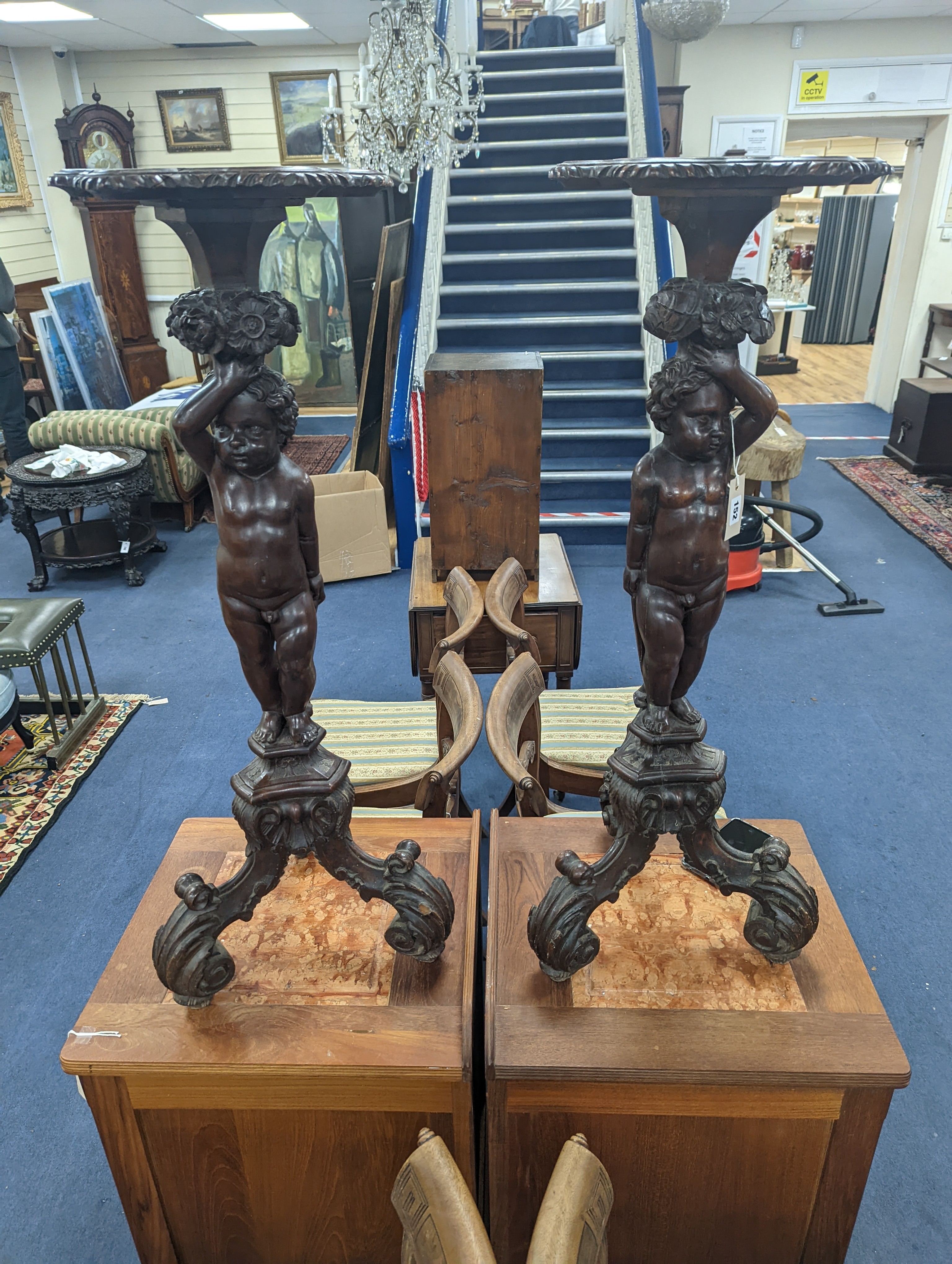 A pair of 18th century style Italian carved walnut figural torcheres with cherub stems, height 96cm